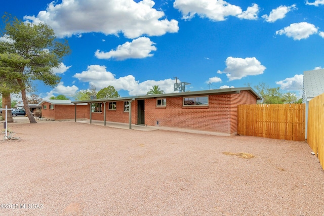 7433 E 19th St, Tucson, AZ 85710 - view of front of house with brick siding and a patio