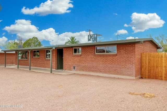 7433 E 19th St, Tucson, AZ 85710 - back of house with brick siding and a patio