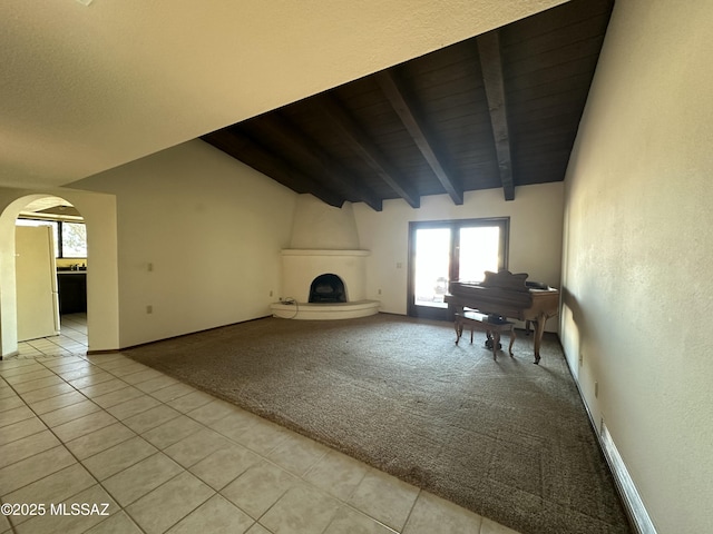 4241 E Aquarius Dr, Tucson, AZ 85718 - unfurnished living room with light tile patterned floors, arched walkways, plenty of natural light, light carpet, and wood ceiling
