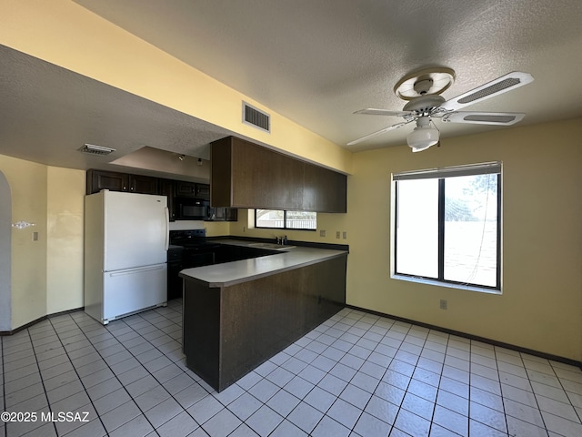 4241 E Aquarius Dr, Tucson, AZ 85718 - kitchen with black appliances, a peninsula, a textured ceiling, light tile patterned flooring, and ceiling fan