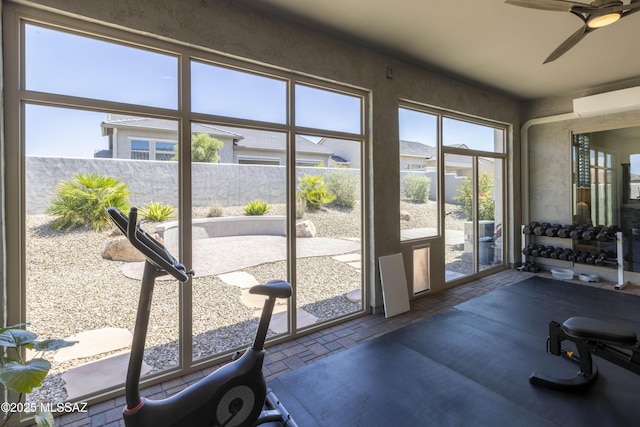 61672 E Talc St, Oracle, AZ 85623 - gym featuring brick flooring, a wall mounted AC, and a ceiling fan