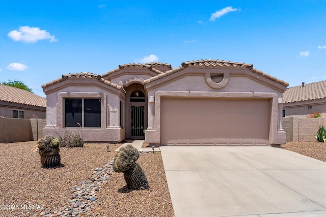 2311 N Creek Vista Dr, Tucson, AZ 85749 - mediterranean / spanish-style home with stucco siding, concrete driveway, a garage, and a tile roof