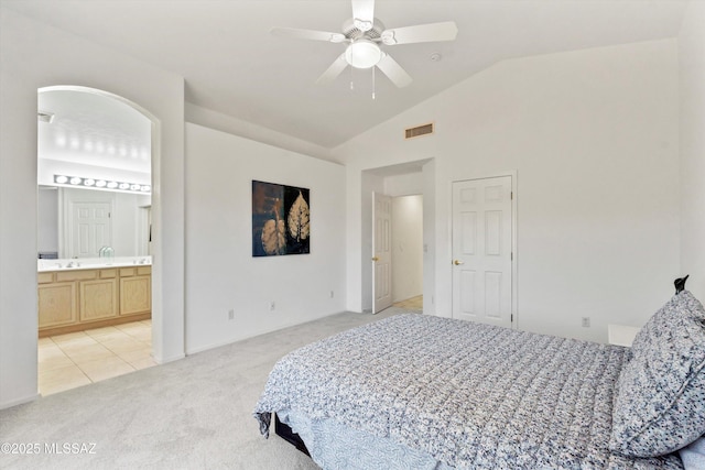 2311 N Creek Vista Dr, Tucson, AZ 85749 - bedroom with light colored carpet, lofted ceiling, a ceiling fan, and connected bathroom