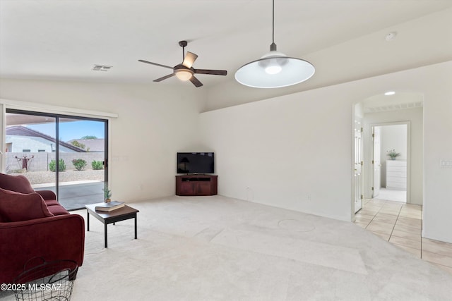2311 N Creek Vista Dr, Tucson, AZ 85749 - living room with vaulted ceiling, ceiling fan, arched walkways, light carpet, and light tile patterned flooring