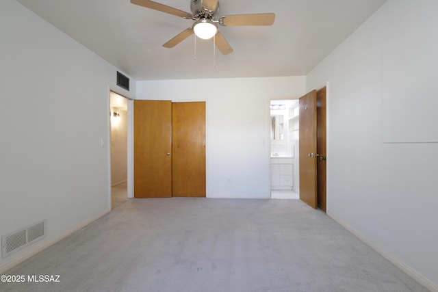 3010 E Sylvia St, Tucson, AZ 85716 - unfurnished bedroom with light carpet, ensuite bath, and baseboards