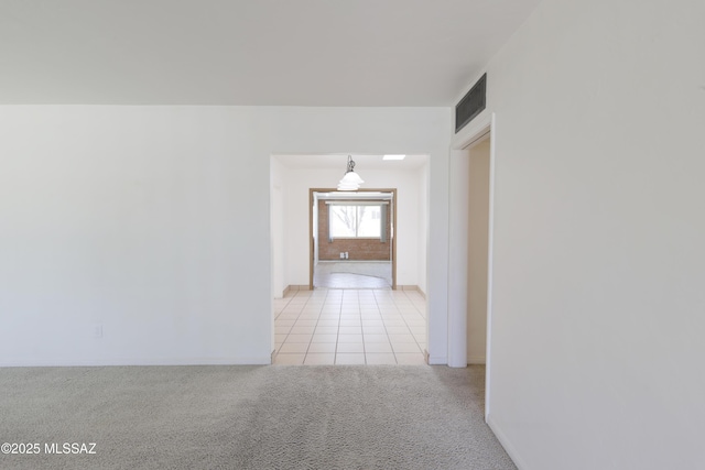 3010 E Sylvia St, Tucson, AZ 85716 - corridor featuring light colored carpet, light tile patterned floors, and baseboards