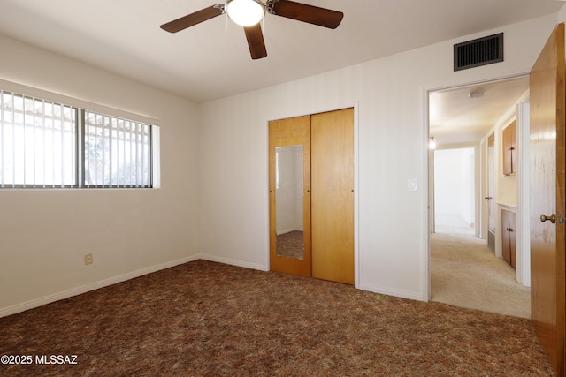 3010 E Sylvia St, Tucson, AZ 85716 - unfurnished bedroom featuring carpet flooring, a closet, a ceiling fan, and baseboards