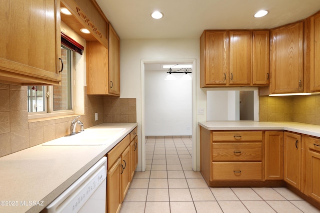 3010 E Sylvia St, Tucson, AZ 85716 - kitchen with white dishwasher, light countertops, recessed lighting, decorative backsplash, and light tile patterned floors