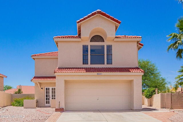 8951 N Fitzgerald Ln, Oro Valley, AZ 85742 - mediterranean / spanish-style home with an attached garage, a tile roof, concrete driveway, and stucco siding