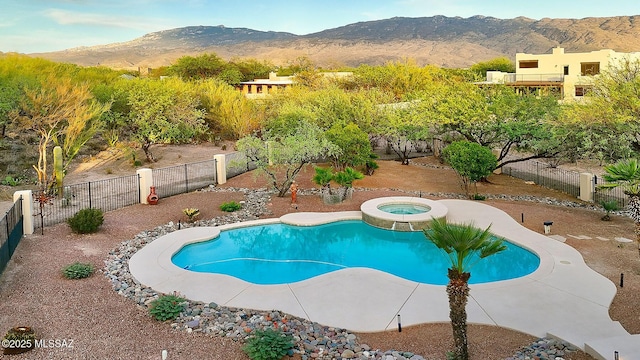 2500 N Fennimore Ave, Tucson, AZ 85749 - view of swimming pool with a mountain view, an in-ground hot tub, and a fenced backyard