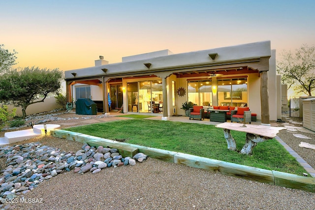 2500 N Fennimore Ave, Tucson, AZ 85749 - back of property featuring an outdoor hangout area, a patio area, a yard, stucco siding, and a chimney