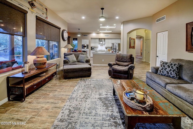 2500 N Fennimore Ave, Tucson, AZ 85749 - living room featuring arched walkways, a ceiling fan, baseboards, and recessed lighting