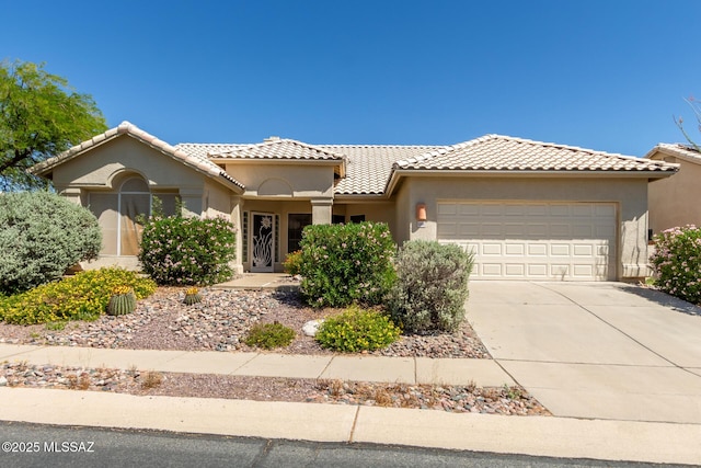 11301 N Silver Pheasant Loop, Tucson, AZ 85737 - mediterranean / spanish house with an attached garage, driveway, stucco siding, and a tile roof