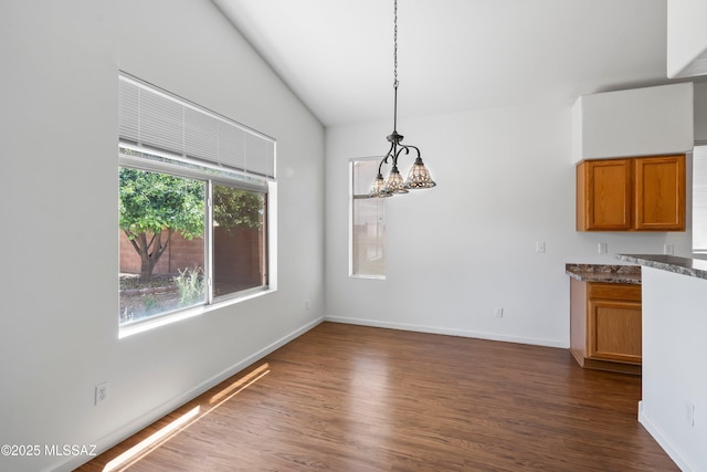 9488 N Elan Ln, Tucson, AZ 85742 - unfurnished dining area with dark wood finished floors and baseboards