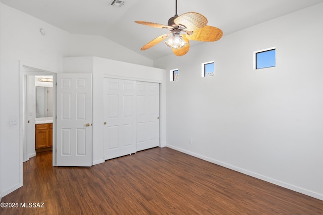 9488 N Elan Ln, Tucson, AZ 85742 - unfurnished bedroom featuring dark wood-type flooring, vaulted ceiling, baseboards, and a closet