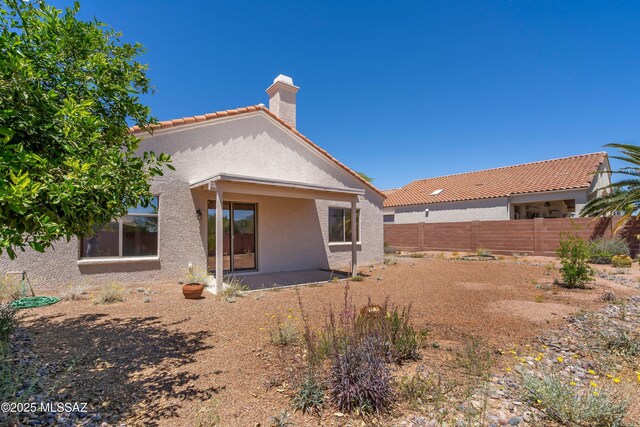 9488 N Elan Ln, Tucson, AZ 85742 - back of property with stucco siding, a chimney, a patio, and a tiled roof