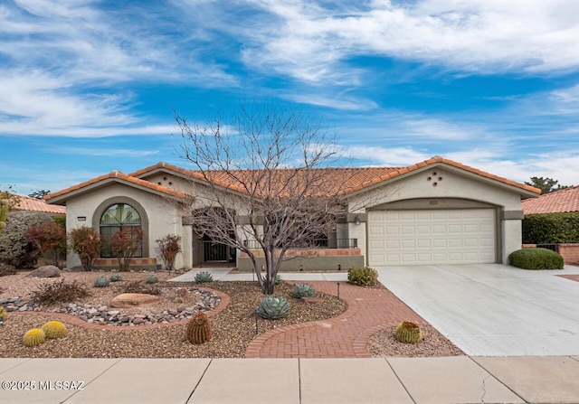 14488 N Rock Springs Ln, Oro Valley, AZ 85755 - mediterranean / spanish-style home featuring stucco siding, an attached garage, driveway, and a tiled roof