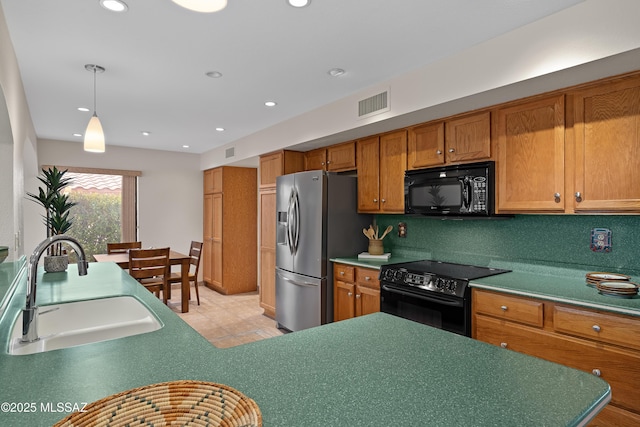 14488 N Rock Springs Ln, Oro Valley, AZ 85755 - kitchen with black appliances, a sink, brown cabinetry, light tile patterned floors, and recessed lighting