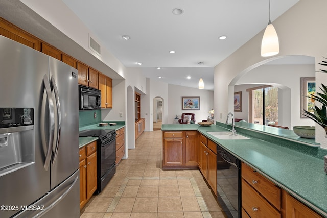 14488 N Rock Springs Ln, Oro Valley, AZ 85755 - kitchen with black appliances, arched walkways, a sink, brown cabinetry, and hanging light fixtures