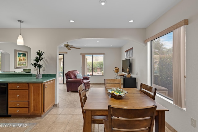 14488 N Rock Springs Ln, Oro Valley, AZ 85755 - dining area with arched walkways, light tile patterned floors, ceiling fan, and recessed lighting