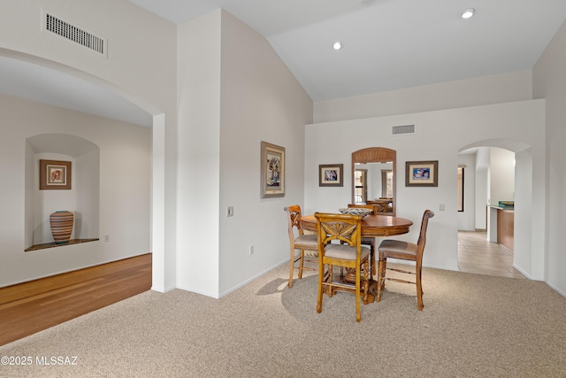 14488 N Rock Springs Ln, Oro Valley, AZ 85755 - dining room with high vaulted ceiling, light colored carpet, baseboards, arched walkways, and recessed lighting