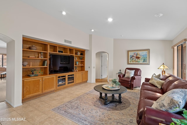 14488 N Rock Springs Ln, Oro Valley, AZ 85755 - living area featuring arched walkways, vaulted ceiling, baseboards, light tile patterned floors, and recessed lighting