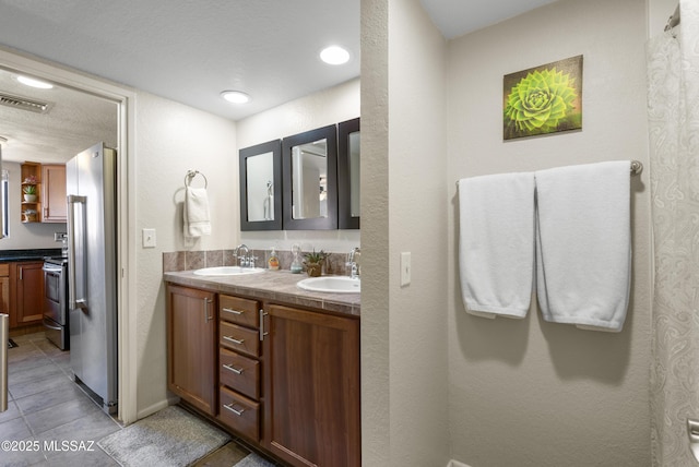 5051 N Sabino Canyon Rd Unit 2162, Tucson, AZ 85750 - full bathroom with double vanity, tile patterned flooring, and baseboards