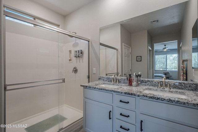 14171 E Adeline Dr, Vail, AZ 85641 - ensuite bathroom with double vanity, a ceiling fan, and a stall shower