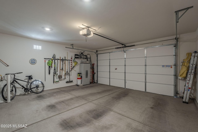 14171 E Adeline Dr, Vail, AZ 85641 - garage with a garage door opener and freestanding refrigerator