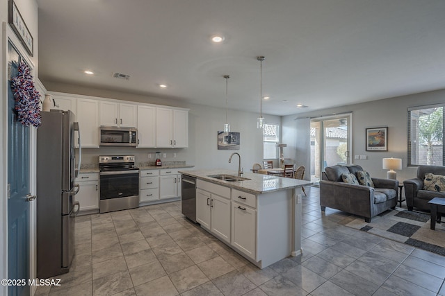 14171 E Adeline Dr, Vail, AZ 85641 - kitchen featuring appliances with stainless steel finishes, a sink, open floor plan, white cabinets, and recessed lighting