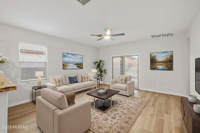 11358 W Folsom Point Dr, Marana, AZ 85658 - living area featuring light wood-style floors, healthy amount of natural light, and a ceiling fan