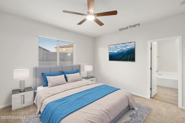 11358 W Folsom Point Dr, Marana, AZ 85658 - carpeted bedroom featuring baseboards, ensuite bath, and a ceiling fan