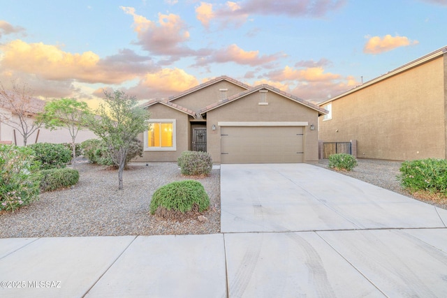 11358 W Folsom Point Dr, Marana, AZ 85658 - view of front of house with a garage, stucco siding, driveway, and a tile roof
