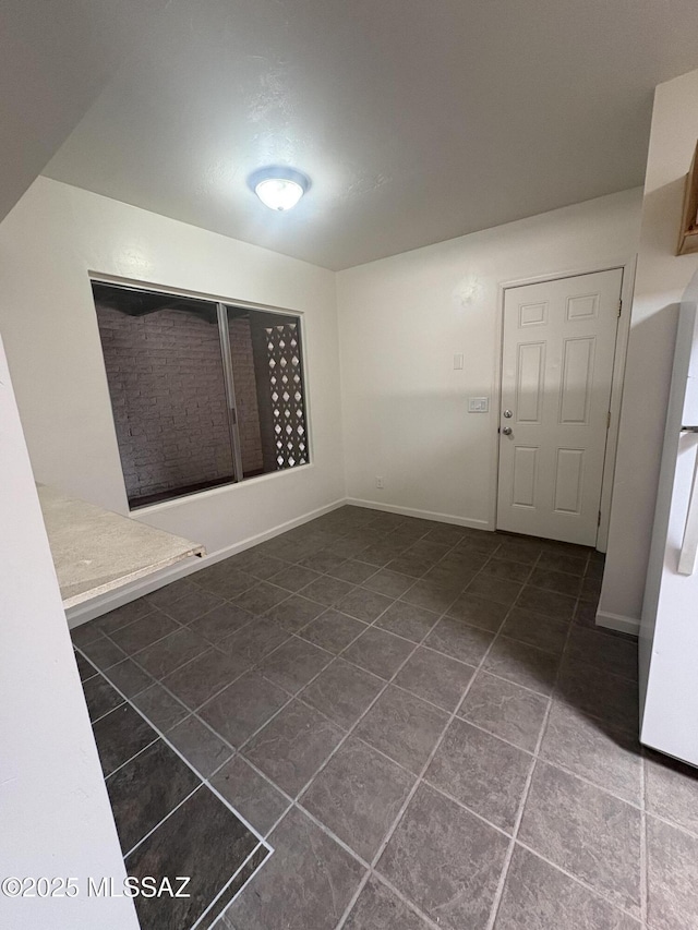 1166 Zircon Ct, Rio Rico, AZ 85648 - spare room featuring dark tile patterned floors and baseboards