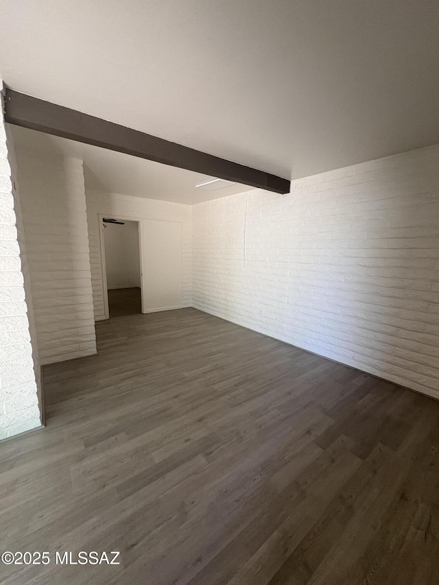 1166 Zircon Ct, Rio Rico, AZ 85648 - spare room with brick wall and dark wood-style flooring