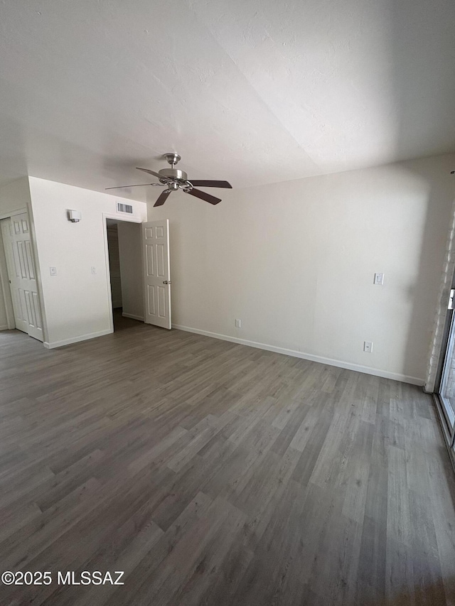 1166 Zircon Ct, Rio Rico, AZ 85648 - unfurnished living room featuring dark wood-style floors, ceiling fan, and baseboards