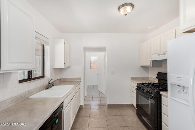 1111 E Lester St, Tucson, AZ 85719 - kitchen featuring black appliances, under cabinet range hood, healthy amount of natural light, and tasteful backsplash