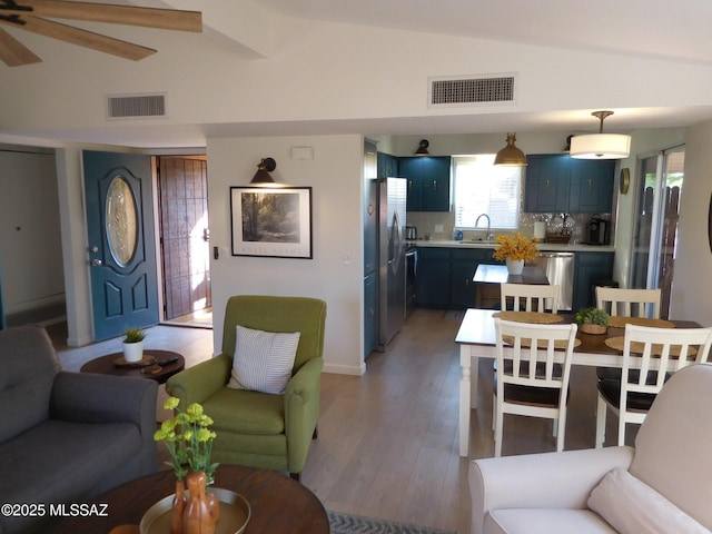 1771 S Desert Vista Dr, Tucson, AZ 85748 - living area featuring lofted ceiling, a ceiling fan, plenty of natural light, and light wood-type flooring