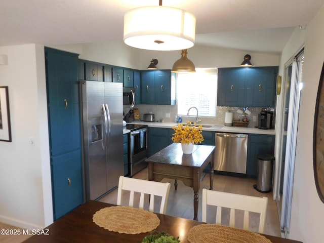 1771 S Desert Vista Dr, Tucson, AZ 85748 - kitchen featuring stainless steel appliances, blue cabinets, tasteful backsplash, a sink, and lofted ceiling