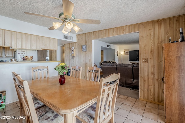 3090 W Alaska St, Tucson, AZ 85746 - dining area featuring wood walls, light tile patterned floors, a textured ceiling, and ceiling fan