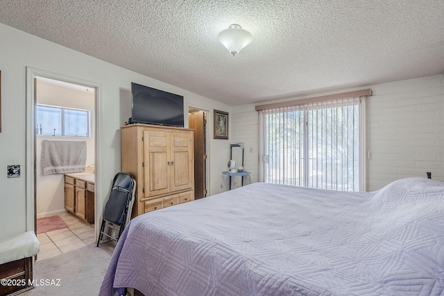 3090 W Alaska St, Tucson, AZ 85746 - bedroom with a textured ceiling, light carpet, ensuite bath, and light tile patterned floors