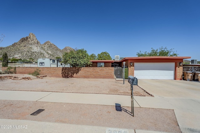 3090 W Alaska St, Tucson, AZ 85746 - view of front facade featuring a garage, concrete driveway, brick siding, and a mountain view