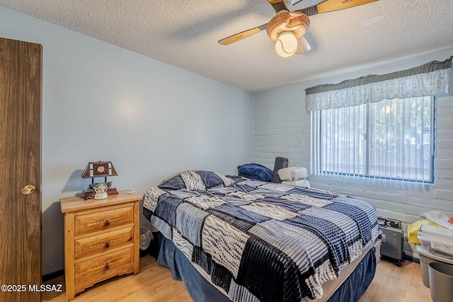 3090 W Alaska St, Tucson, AZ 85746 - bedroom with light wood finished floors, a textured ceiling, and ceiling fan