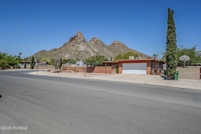 3090 W Alaska St, Tucson, AZ 85746 - view of front of house with a mountain view, brick siding, and a garage