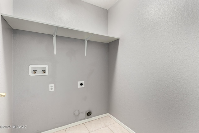 2649 W Catalina View Dr, Tucson, AZ 85742 - laundry area with hookup for a washing machine, hookup for a gas dryer, electric dryer hookup, light tile patterned floors, and baseboards