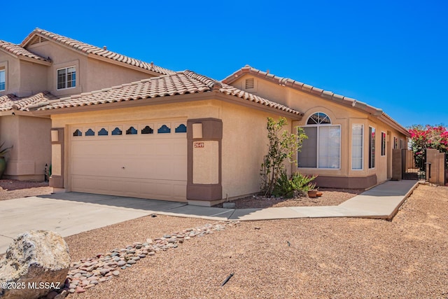 2649 W Catalina View Dr, Tucson, AZ 85742 - mediterranean / spanish home with stucco siding, driveway, an attached garage, and a tiled roof