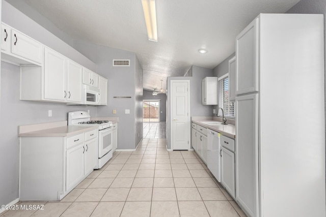 2649 W Catalina View Dr, Tucson, AZ 85742 - kitchen with white appliances, a sink, light countertops, light tile patterned floors, and recessed lighting