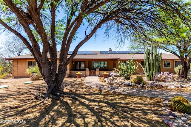 3740 W Placita Fantasia, Tucson, AZ 85745 - back of house featuring solar panels, a shingled roof, and stucco siding