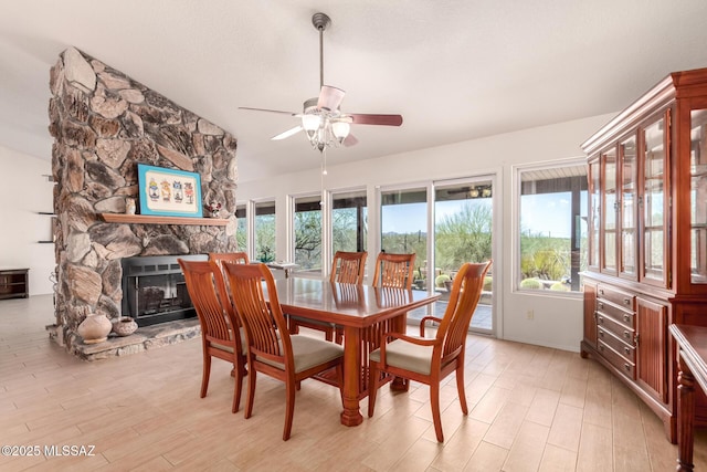 3740 W Placita Fantasia, Tucson, AZ 85745 - dining area with ceiling fan, light wood-style floors, and a stone fireplace