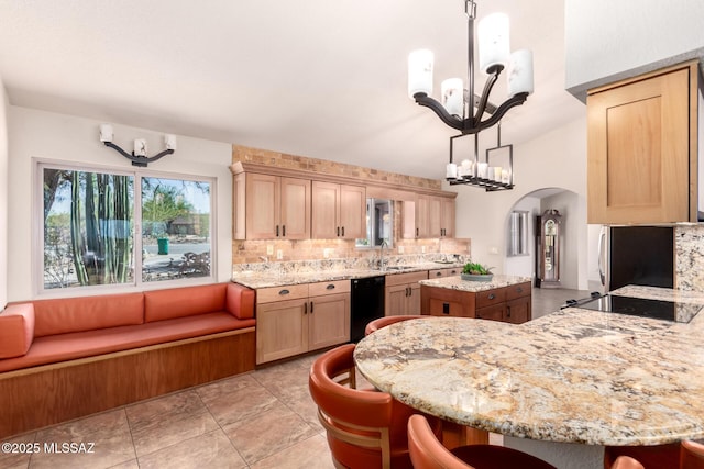 3740 W Placita Fantasia, Tucson, AZ 85745 - kitchen with a sink, a chandelier, black appliances, a kitchen island, and decorative backsplash
